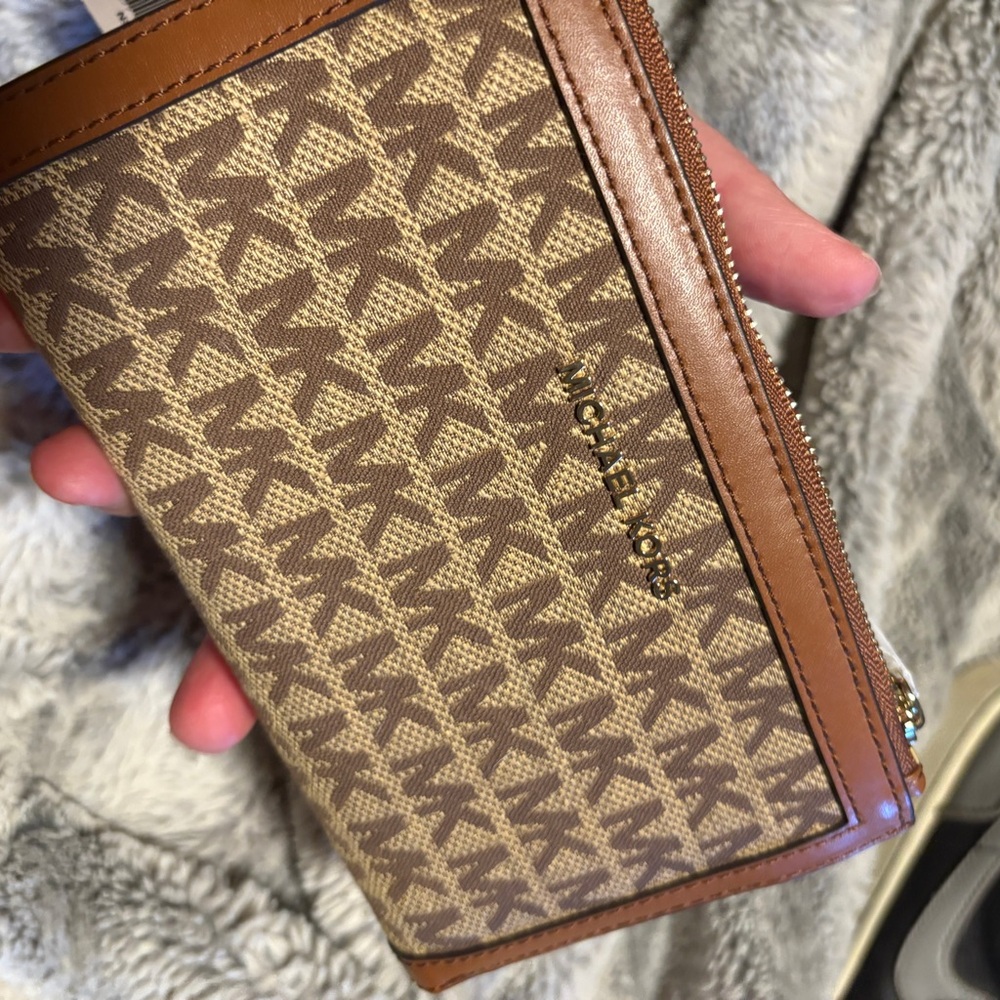 Michael Kors Brown and tan Zip wallet with a phone pocket! Lots of pockets!